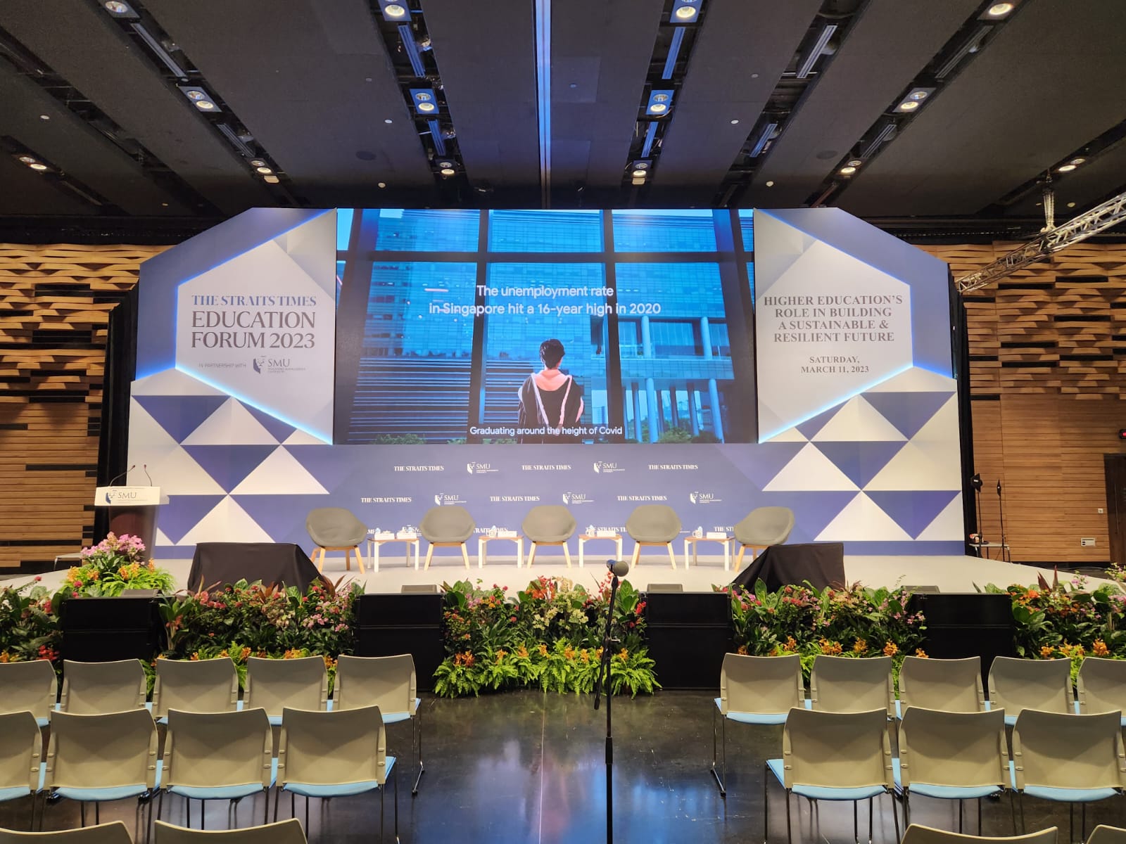 A*STAR conference setup with projection screens and wireless microphone systems